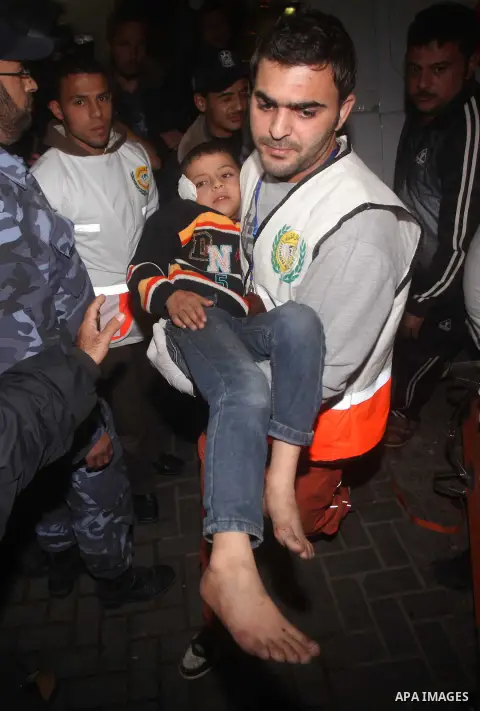 Palestinians carries an man into the treatment room of Shifa hospital following an Israeli airstrike, in Gaza City, Friday, Nov. 16, 2012. Fierce clashes between Israeli forces and Gaza militants are continuing for the t...