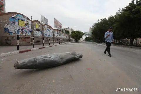 A Hamas policeman stands near an unexploded missile fired by an Israeli aircraft in Gaza City November 17, 2012. Israeli aircraft pounded Hamas government buildings in Gaza on Saturday, including the building housing the...