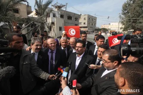 Tunisia's Foreign Minister Rafik Abdessalem visits the office building of Hamas Prime Minister Ismail Haniyeh that was destroyed by an Israeli air strike in Gaza City November 17, 2012. Israeli aircraft pounded Hamas gov...