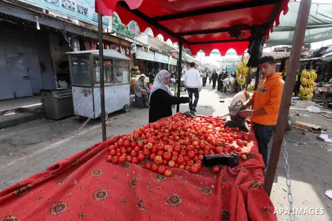 Palestinians shops at a market, while Israeli aircraft continue the military operation on Gaza strip, in central Gaza city on November 17, 2012. Israeli aircraft bombed Hamas government buildings in Gaza on Saturday, inc...