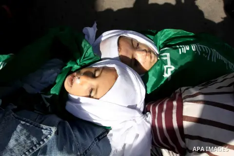 Palestinians carry the bodies of two children during their funeral in the northern Gaza Strip November 18, 2012. Two children Jumana Abu Seifan, 18 months old, and her brother Tamer, three and a half years old, were kill...