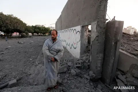 A Palestinian man inspects the damage after an Israeli airstrike in the central of Gaza city, November 18, 2012. Israeli war planes hit a Gaza City media centre and homes in northern Gaza in the early morning, as the dea...
