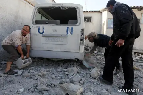 Palestinians inspect the damage at a UN Supply Center after being damaged by an Israeli airstrike directed at a Hamas police headquarters nearby in Jabalya refugee camp northern of Gaza Strip on November 18, 2012. A grou...