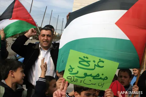 Palestinian children shout slogans and hold placards during a protest in solidarity with the children of Gaza, in the West Bank city of Hebron, on November 18, 2012. Israeli aircraft killed five Palestinian children in o...