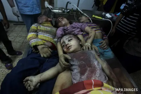 The bodies of four children from the al-Dallu family lay in a hospital after an Israeli missile struck a family home in Gaza City, on November 18, 2012. Ten Palestinian civilians were killed on Sunday in an Israeli air s...
