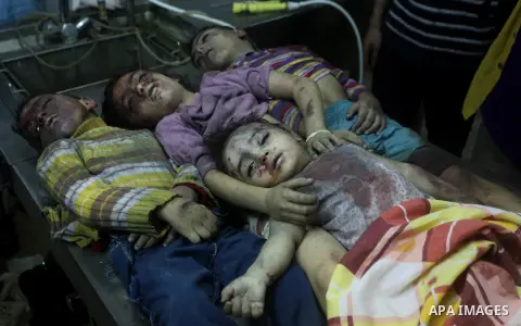 The bodies of four children from the al-Dallu family lay in a hospital after an Israeli missile struck a family home in Gaza City, on November 18, 2012. Ten Palestinian civilians were killed on Sunday in an Israeli air s...