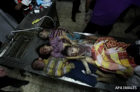 The bodies of four children from the al-Dallu family lay in a hospital after an Israeli missile struck a family home in Gaza City, on November 18, 2012. Ten Palestinian civilians were killed on Sunday in an Israeli air s...