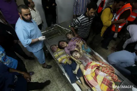 The bodies of four children from the al-Dallu family lay in a hospital after an Israeli missile struck a family home in Gaza City, on November 18, 2012. Ten Palestinian civilians were killed on Sunday in an Israeli air s...