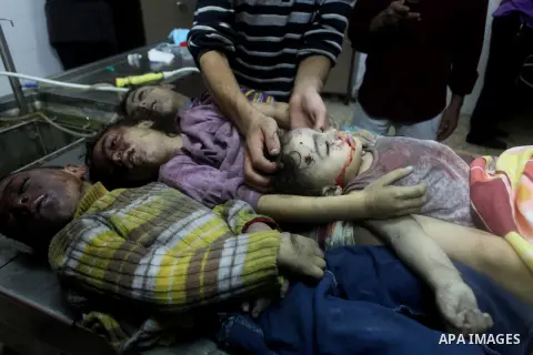 The bodies of four children from the al-Dallu family lay in a hospital after an Israeli missile struck a family home in Gaza City, on November 18, 2012. Ten Palestinian civilians were killed on Sunday in an Israeli air s...