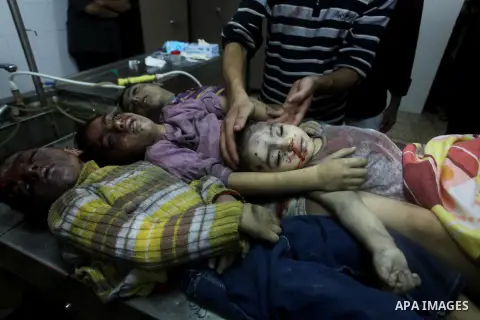 The bodies of four children from the al-Dallu family lay in a hospital after an Israeli missile struck a family home in Gaza City, on November 18, 2012. Ten Palestinian civilians were killed on Sunday in an Israeli air s...