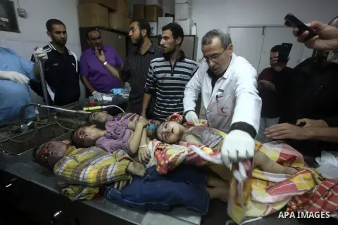 The bodies of four children from the al-Dallu family lay in a hospital after an Israeli missile struck a family home in Gaza City, on November 18, 2012. Ten Palestinian civilians were killed on Sunday in an Israeli air s...