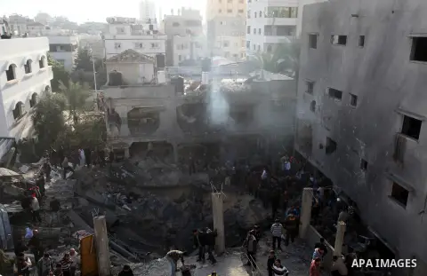 Palestinians search through the debris of the destroyed home of the al-Dallu family following an Israeli air strike in Gaza City, on November 18, 2012. Ten Palestinian civilians were killed on Sunday in an Israeli air st...
