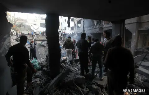Palestinians search through the debris of the destroyed home of the al-Dallu family following an Israeli air strike in Gaza City, on November 18, 2012. Ten Palestinian civilians were killed on Sunday in an Israeli air st...
