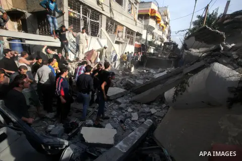 Palestinians search through the debris of the destroyed home of the al-Dallu family following an Israeli air strike in Gaza City, on November 18, 2012. Ten Palestinian civilians were killed on Sunday in an Israeli air st...