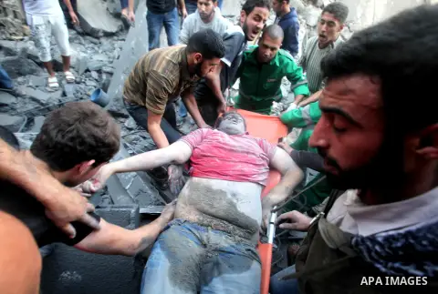 Palestinians carry the dead body of a man from the al-Dallu family out from the rubble after an Israeli airstrike in Gaza City, on November 18, 2012. Ten Palestinian civilians were killed on Sunday in an Israeli air stri...