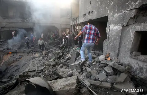 Palestinians search through the debris of the destroyed home of the al-Dallu family following an Israeli air strike in Gaza City, on November 18, 2012. Ten Palestinian civilians were killed on Sunday in an Israeli air st...