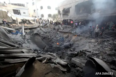 Palestinians search through the debris of the destroyed home of the al-Dallu family following an Israeli air strike in Gaza City, on November 18, 2012. Ten Palestinian civilians were killed on Sunday in an Israeli air st...