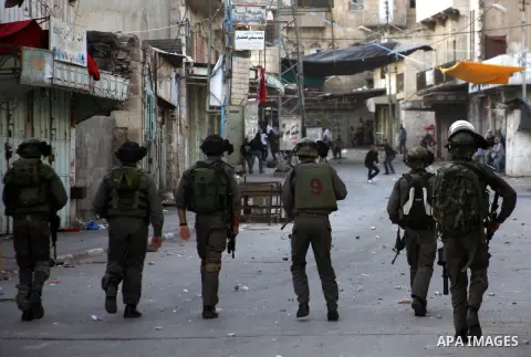 Palestinians in the West Bank city of Hebron protest by throwing stones against Israeli soldiers and security forces, 18 November 2012. Palestinians from the West Bank show their solidarity with Palestinians in the Gaza...