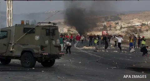 Palestinian protesters throw stones at Israeli soldiers during clashes following a protest against Israel's operations in the Gaza Strip, at Howwara checkpoint near Nablus, the West Bank, 18 November 2012. Reports state...
