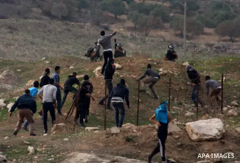 Palestinian protesters throw stones at Israeli soldiers during clashes following a protest against Israel's operations in the Gaza Strip, at Howwara checkpoint near Nablus, the West Bank, 18 November 2012. Reports state...