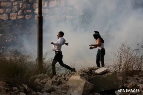 Palestinian protesters throw stones at Israeli soldiers during clashes following a protest against Israel's operations in the Gaza Strip, at Howwara checkpoint near Nablus, the West Bank, 18 November 2012. Reports state...