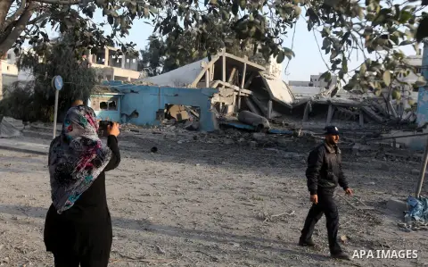 Palestinians survey the remains of a destroyed police station after Israeli air strike in al-Shijaia in the east of Gaza city on, 19 November 2012. The Palestinian civilian death toll mounted Monday as Israeli aircraft s...