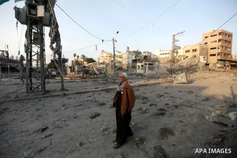 A Palestinian man surveys the remains of a destroyed police station after Israeli air strike in al-Shijaia in the east of Gaza city on, 19 November 2012. The Palestinian civilian death toll mounted Monday as Israeli airc...