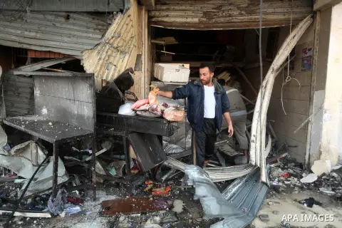 A Palestinian policeman surveys the remains of a destroyed police station after Israeli air strike in al-Shijaia in the east of Gaza city on, 19 November 2012. The Palestinian civilian death toll mounted Monday as Israel...