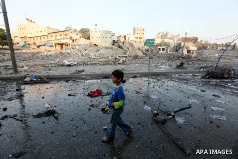 A Palestinian boy surveys the remains of a destroyed police station after Israeli air strike in al-Shijaia in the east of Gaza city on, 19 November 2012. The Palestinian civilian death toll mounted Monday as Israeli airc...