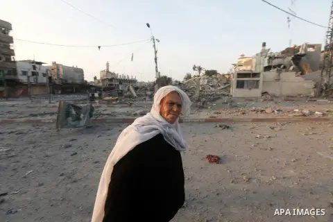 A Palestinian woman surveys the remains of a destroyed police station after Israeli air strike in al-Shijaia in the east of Gaza city on, 19 November 2012. The Palestinian civilian death toll mounted Monday as Israeli ai...