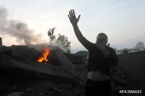 A Palestinian man stands near the debris of destroyed homes following an Israeli air strike in Gaza City, on November 19, 2012. Israeli air strikes on Sunday killed 31 Palestinians in the bloodiest day so far of its air...