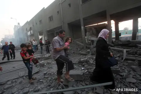 Palestinians walk amongst the debris of destroyed homes following an Israeli air strike in Gaza City, on November 19, 2012. Israeli air strikes on Sunday killed 31 Palestinians in the bloodiest day so far of its air camp...