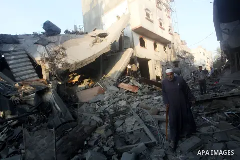 A Palestinian man walks amongst the debris of destroyed homes following an Israeli air strike in Gaza City, on November 19, 2012. Israeli air strikes on Sunday killed 31 Palestinians in the bloodiest day so far of its ai...