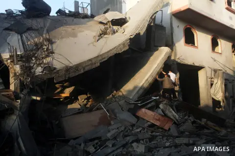 Palestinians search the debris of a destroyed home following an Israeli air strike in Gaza City, on November 19, 2012. Israeli air strikes on Sunday killed 31 Palestinians in the bloodiest day so far of its air campaign...