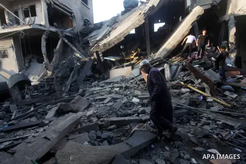 A Palestinian man walks amongst the debris of destroyed homes following an Israeli air strike in Gaza City, on November 19, 2012. Israeli air strikes on Sunday killed 31 Palestinians in the bloodiest day so far of its ai...