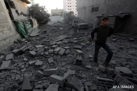 A Palestinian man walks amongst the debris of destroyed homes following an Israeli air strike in Gaza City, on November 19, 2012. Israeli air strikes on Sunday killed 31 Palestinians in the bloodiest day so far of its ai...