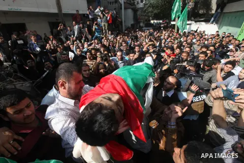 Palestinians carry the bodies of civilian from the al-Dallu family during their funeral in Gaza City, on November 19, 2012.Eleven members of the al-Dallu family were killed on Sunday when an Israeli missile struck the tw...