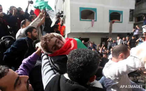 Palestinians carry the bodies of civilian from the al-Dallu family during their funeral in Gaza City, on November 19, 2012.Eleven members of the al-Dallu family were killed on Sunday when an Israeli missile struck the tw...