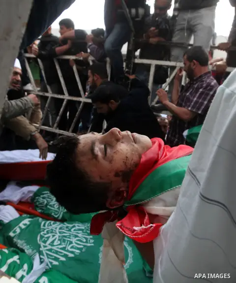 Palestinians carry the bodies of civilian from the al-Dallu family during their funeral in Gaza City, on November 19, 2012.Eleven members of the al-Dallu family were killed on Sunday when an Israeli missile struck the tw...
