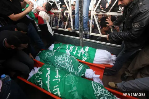 Palestinians carry the bodies of civilian from the al-Dallu family during their funeral in Gaza City, on November 19, 2012.Eleven members of the al-Dallu family were killed on Sunday when an Israeli missile struck the tw...