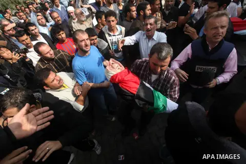 Palestinians carry the bodies of civilian from the al-Dallu family during their funeral in Gaza City, on November 19, 2012.Eleven members of the al-Dallu family were killed on Sunday when an Israeli missile struck the tw...