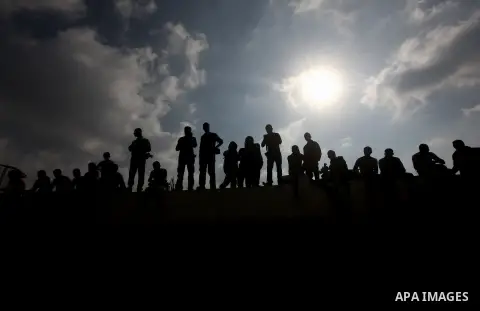 Palestinians gather over the the bodies of civilian from the al-Dallu family during their funeral in Gaza City, on November 19, 2012. Eleven members of the Dallu family were killed on Sunday when an Israeli missile struc...