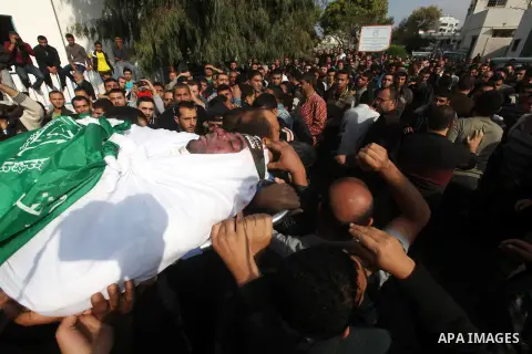 Palestinians carry the body of a member of Hamas militant Ezz el-Deen al-Qassam brigades during his funeral in Gaza City, on November 19, 2012. Media reports state that Israeli forces were on monday targeting the homes a...