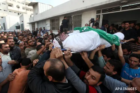 Palestinians carry the body of a member of Hamas militant Ezz el-Deen al-Qassam brigades during his funeral in Gaza City, on November 19, 2012. Media reports state that Israeli forces were on monday targeting the homes a...