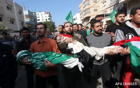 Palestinians carry the bodies of civilian from the al-Dallu family during their funeral in Gaza City, on November 19, 2012.Eleven members of the al-Dallu family were killed on Sunday when an Israeli missile struck the tw...