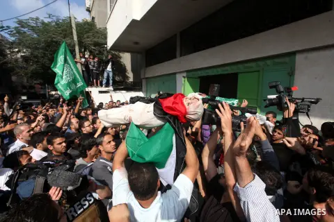 Palestinians carry the bodies of civilian from the al-Dallu family during their funeral in Gaza City, on November 19, 2012.Eleven members of the al-Dallu family were killed on Sunday when an Israeli missile struck the tw...