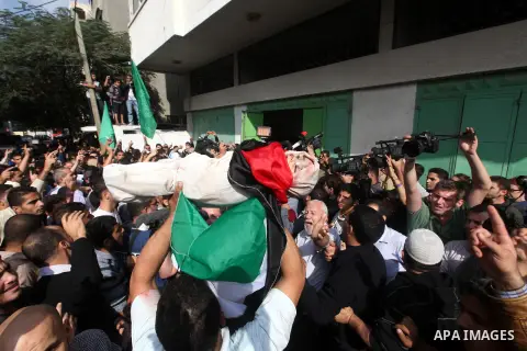 Palestinians carry the bodies of civilian from the al-Dallu family during their funeral in Gaza City, on November 19, 2012.Eleven members of the al-Dallu family were killed on Sunday when an Israeli missile struck the tw...