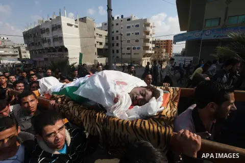 Palestinians carry the bodies of the al-Dallu family during their funeral in Gaza City, 19 November 2012. Nine members of the al-Dallu family died when Israeli forced hit their building in Gaza City one day ago. Media re...