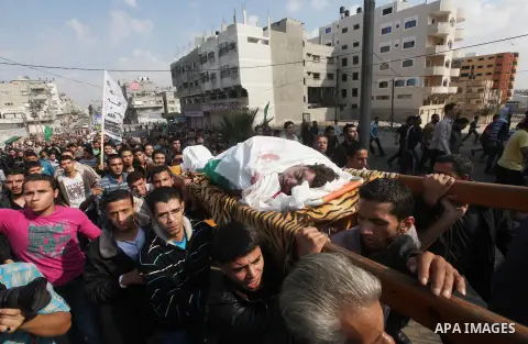 Palestinians carry the bodies of the al-Dallu family during their funeral in Gaza City, 19 November 2012. Nine members of the al-Dallu family died when Israeli forced hit their building in Gaza City one day ago. Media re...