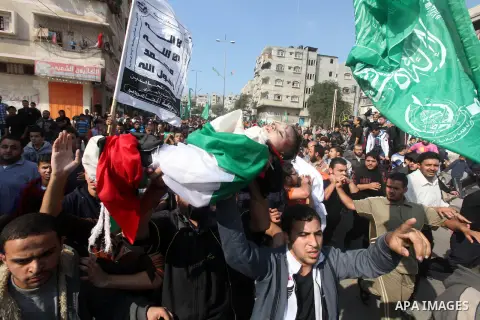 Palestinians carry the bodies of the al-Dallu family during their funeral in Gaza City, 19 November 2012. Nine members of the al-Dallu family died when Israeli forced hit their building in Gaza City one day ago. Media re...